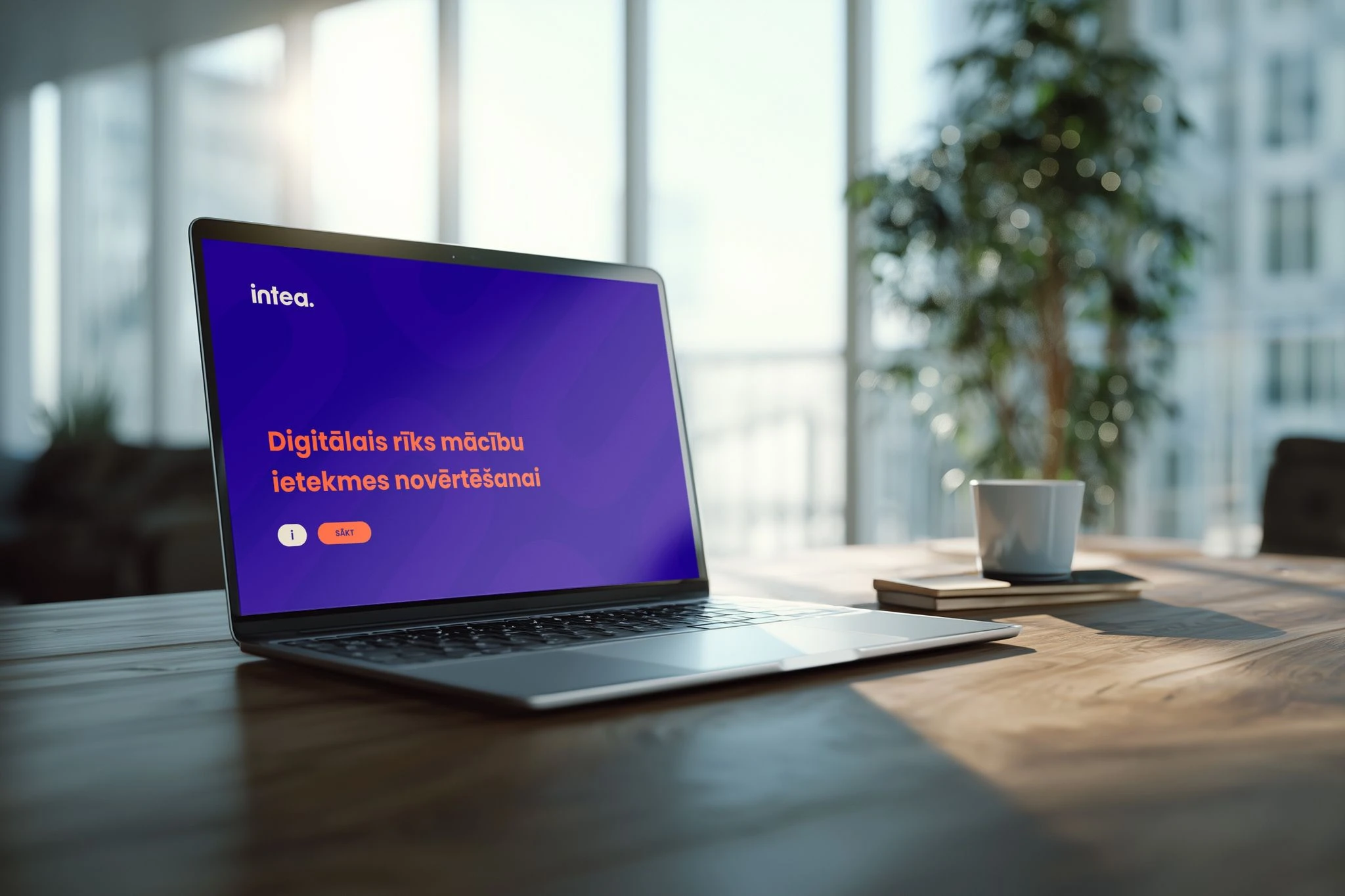 Laptop displaying an INTEA digital learning course on a wooden table.
